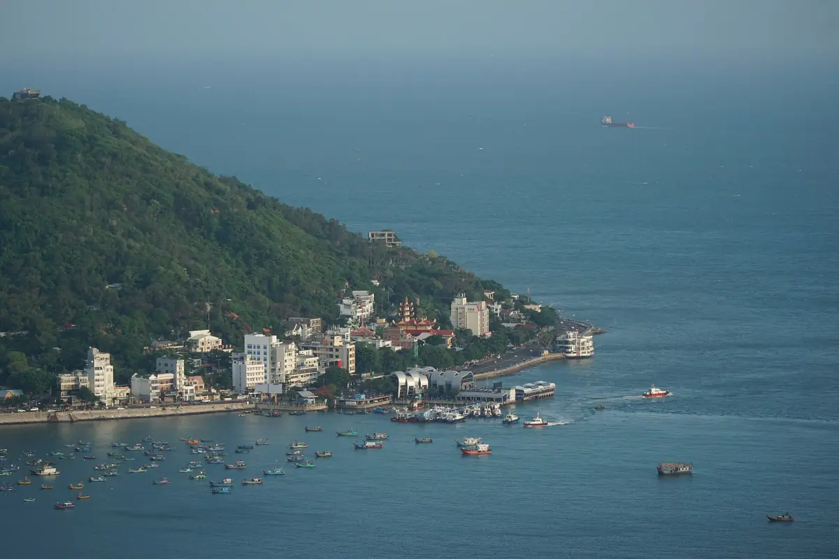 Green headland and Front Beach shoreline of Vung Tau over blue sea