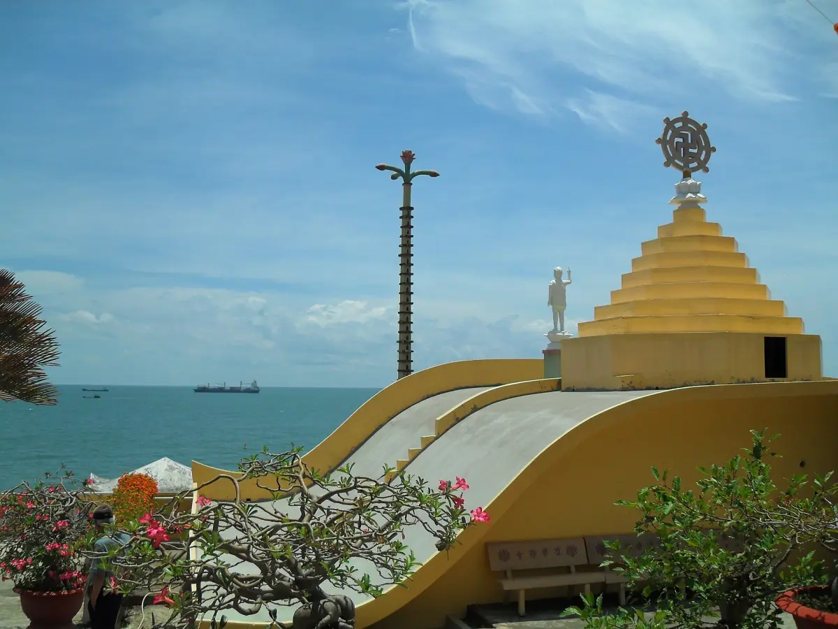 Yellow pagoda roof of Niet Ban Tinh Xa temple above the sea