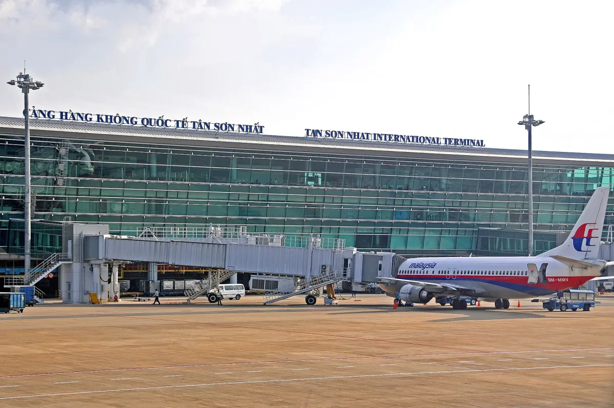 Tan Son Nhat airport terminal building with a parked passenger jet